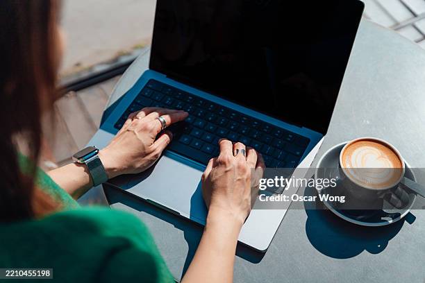 getting work done in sidewalk cafe - working on laptop back stock pictures, royalty-free photos & images
