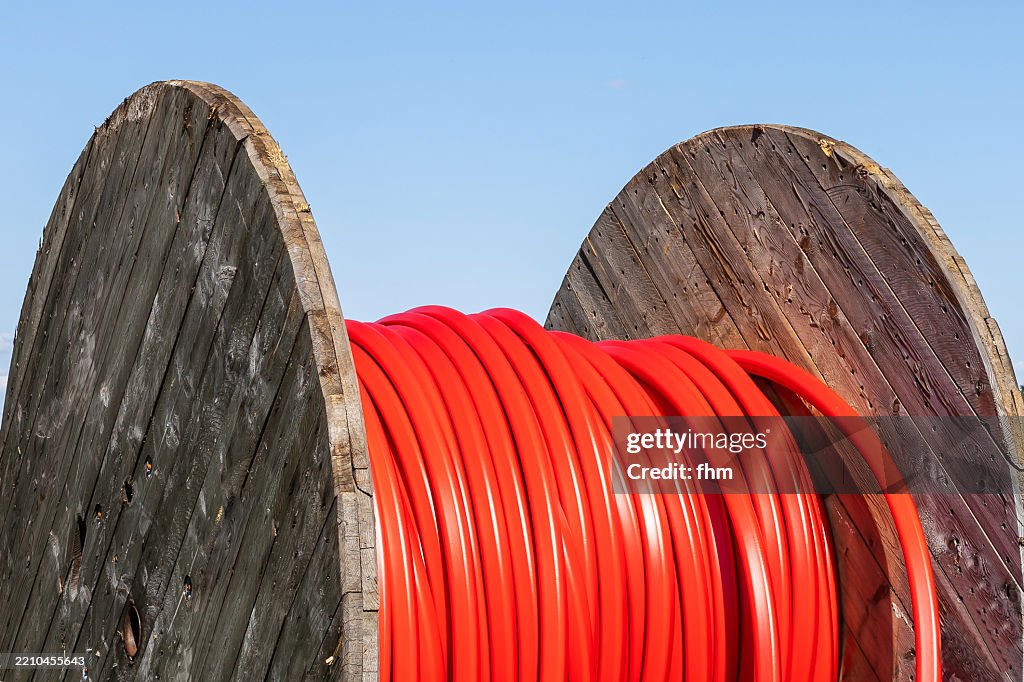 Rolled up red cabel on a cable drum