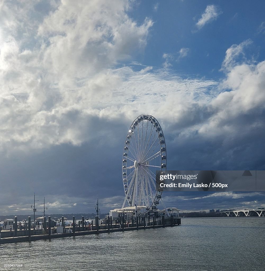 View of ferris wheel against cloudy sky,National Harbor,Maryland,United States,USA