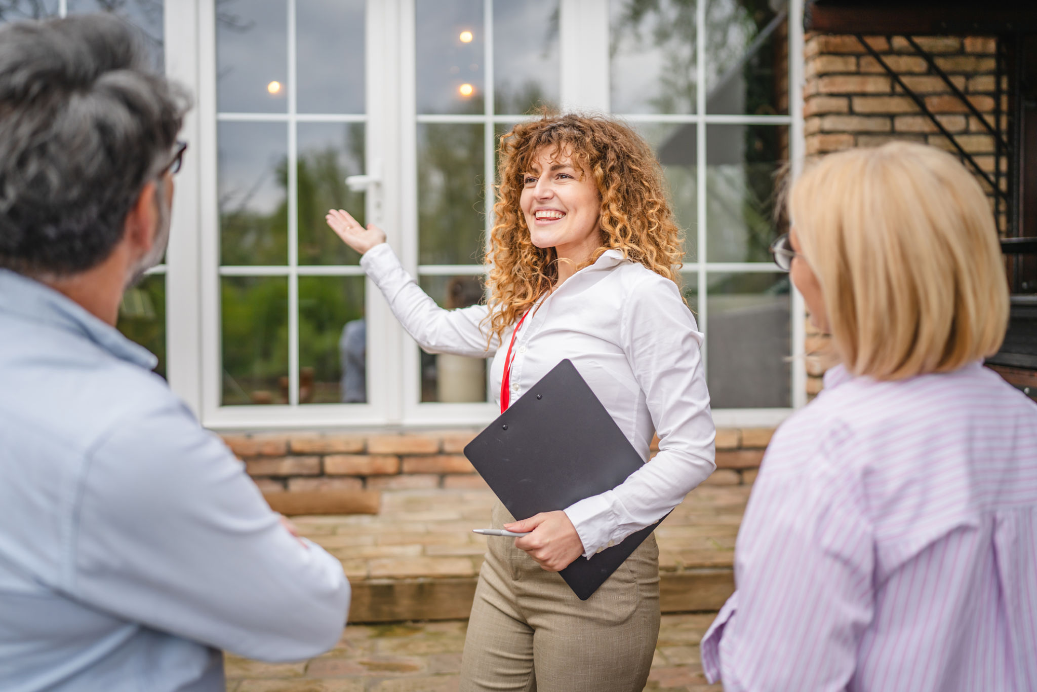 smile woman real estate agent present house to mature couple smile woman real estate agent present house to mature couple