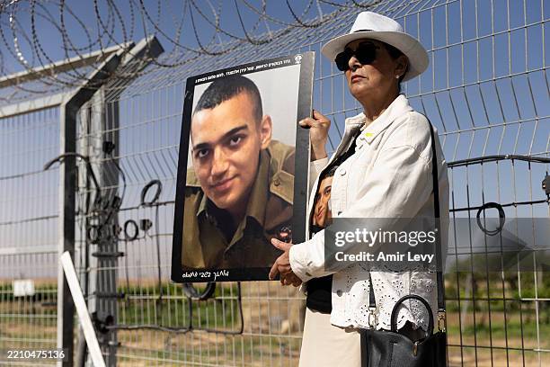 Varda Ben Baruch holds a photo of her grandson Israeli- American hostage Edan Alexander during a rally of families of hostages held in the Gaza Strip...