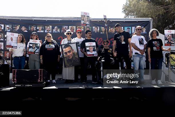 Families of hostages held in the Gaza Strip hold their photos during a rally calling for the release of all hostages on April 20, 2025 in Nir Oz,...
