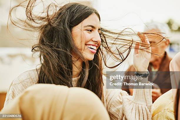 medium close-up shot beautiful joyful woman enjoying family party - exposto pelo vento imagens e fotografias de stock