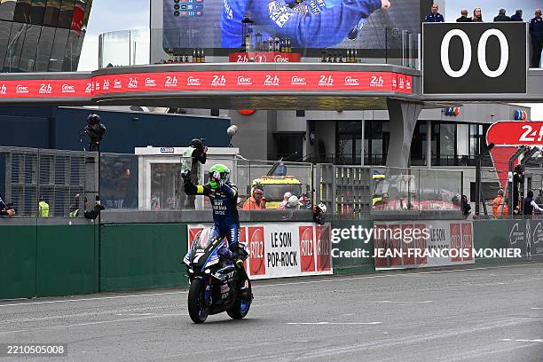 Yart-Yamaha Formula EWC German rider N°7 Marvin Fritz celebrates as he crosses the finish line to win the 48th Le Mans 24-hours endurance moto race,...