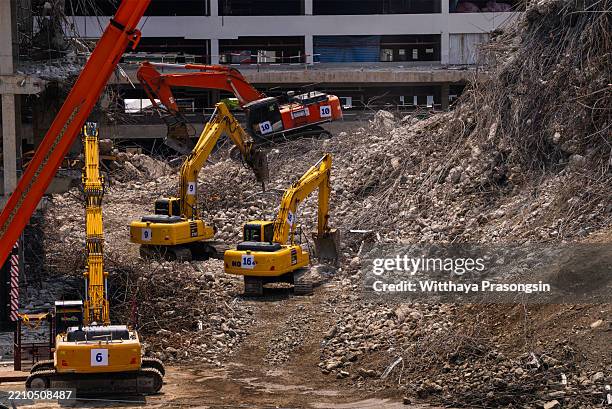 heavy machinery operating in a large construction demolition site - grävmaskin bildbanksfoton och bilder