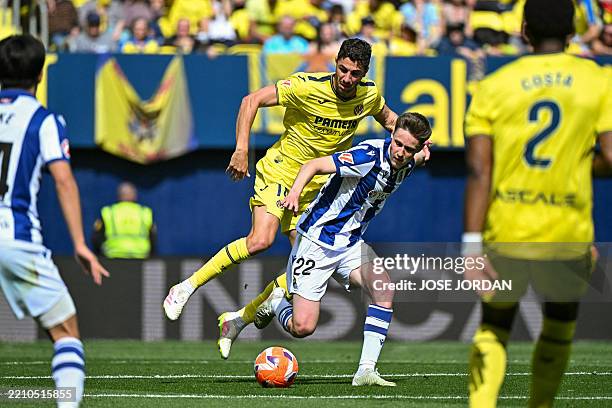 Real Sociedad's Spanish midfielder Benat Turrientes is challenged by Villarreal's Spanish midfielder Santi Comesana during the Spanish league...