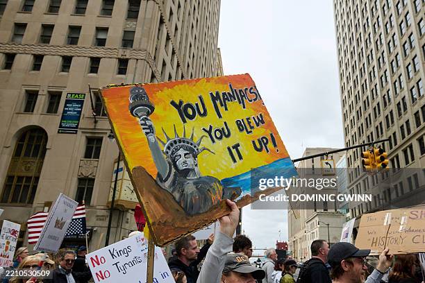 People affiliated with the 50501 movement march through downtown Detroit, Michigan on Saturday, April 19 to protest the Trump administration on the...