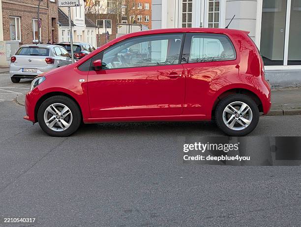 compact seat mii in bright red, parked on the side of the road in a hamburg residential are - hatchback stock pictures, royalty-free photos & images