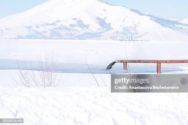 black liquid heavy metals are discharged into a septic tank and a lake, polluting the environment - sump pump stock pictures, royalty-free photos & images