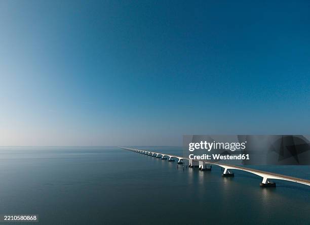 aerial view of the zeelandbrug bridge over the oosterschelde tidal estuary in the netherlands - eastern scheldt stock pictures, royalty-free photos & images