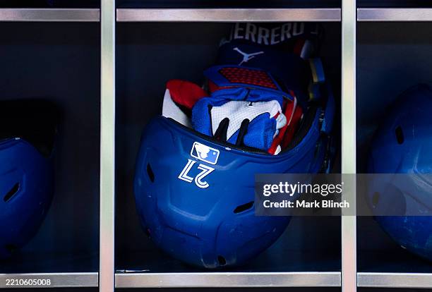 The helmet and batting gloves of Vladimir Guerrero Jr. #27 of the Toronto Blue Jays are seen in dugout ahead of the game against the Atlanta Braves...