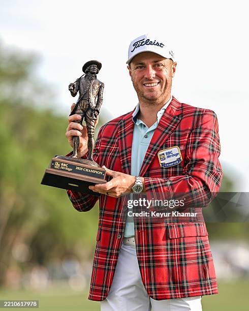 Justin Thomas smiles with the tournament trophy and plaid tartan jacket after his playoff victory in the final round of the RBC Heritage at Harbour...