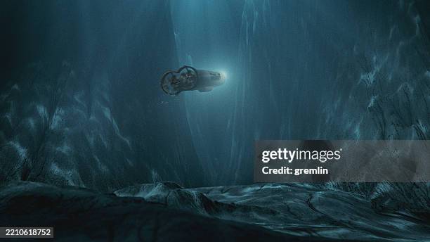 concept image of deep underwater ocean exploration with submarine - remotely operated underwater vehicle stockfoto's en -beelden