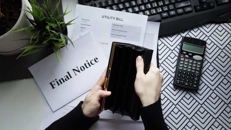 Empty Account Hands with an empty wallet with utility bills, account summary and due ...