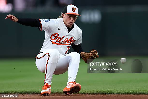 Jackson Holliday of the Baltimore Orioles cannot field a hit by Carlos Santana of the Cleveland Guardians during the fourth inning at Oriole Park at...