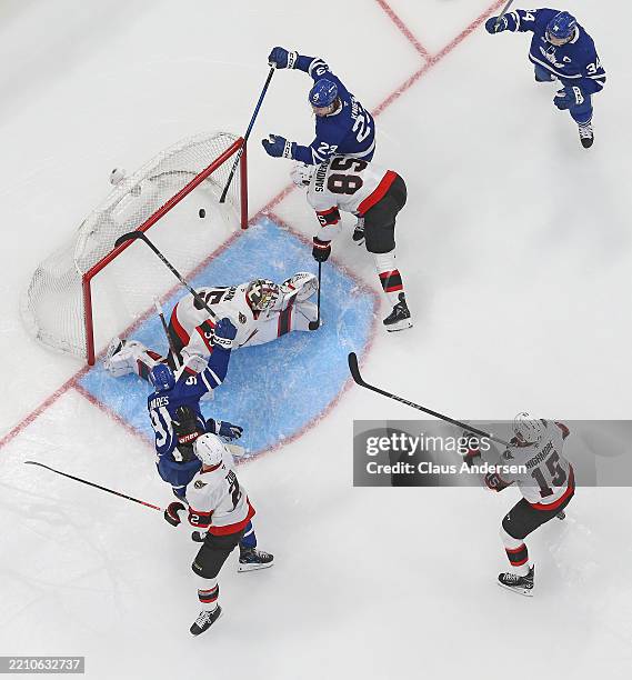 John Tavares of the Toronto Maple Leafs scores a goal against Linus Ullmark of the Ottawa Senators in the second period of Game One of the First...