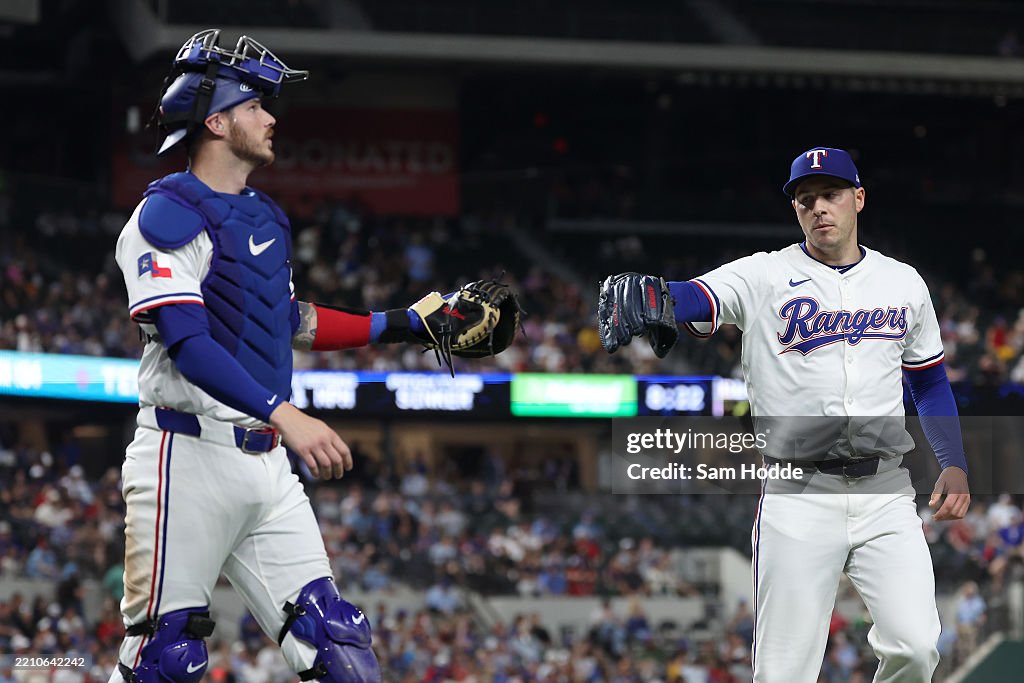 Texas Ranger Heim Patrick Corbin and Jonah Heim of the Texas Rangers bump gloves as ...