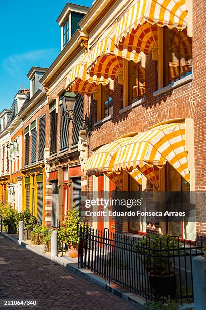 façades of traditional and historical dutch houses on a calm street - friesland district stock pictures, royalty-free photos & images