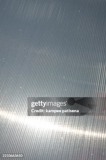 A shiny silver polycarbonate surface with a pattern A shiny silver polycarbonate surface with a pattern