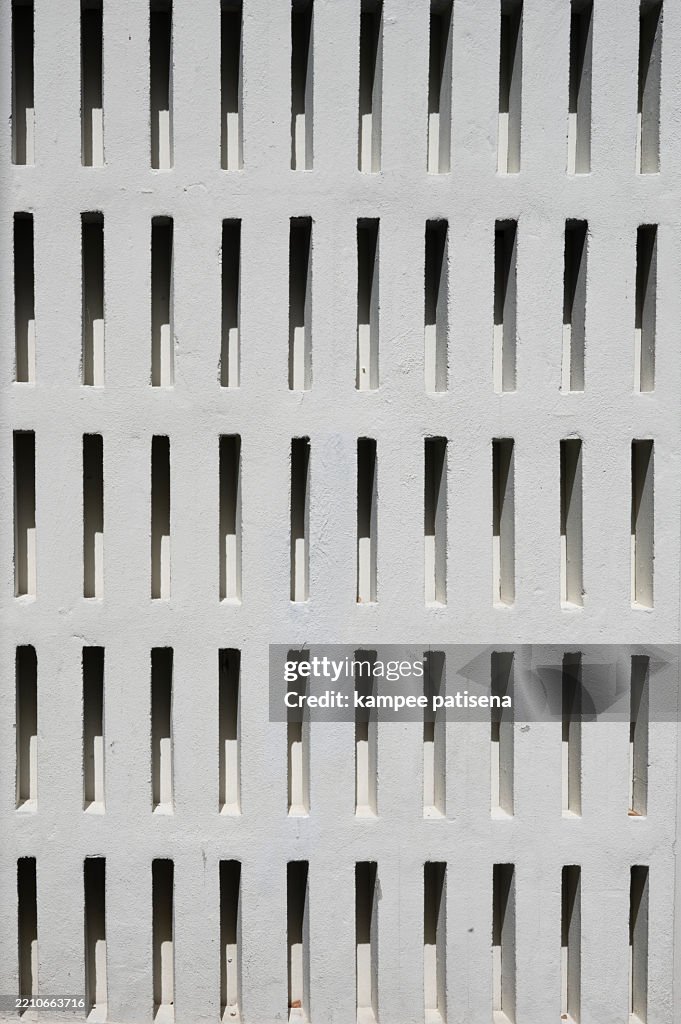 A wall with a pattern of holes