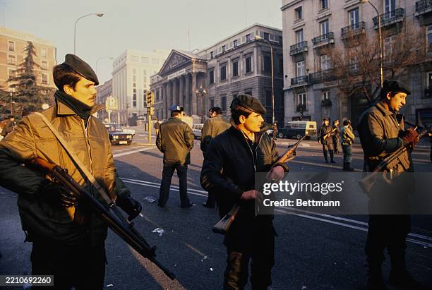 Soldiers standing guard in the street outside the Palacio de las Cortes, the Spanish parliament, the day after an attempted military coup, Madrid,...