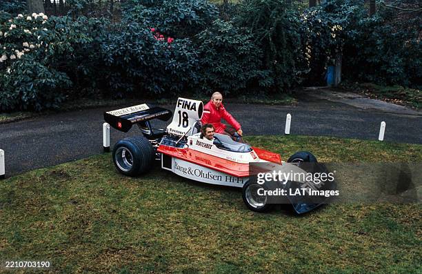 Jochen Mass sits in the cockpit of the Surtees TS16 Ford with John Surtees sat on the sidepod, United Kingdom, 1974.