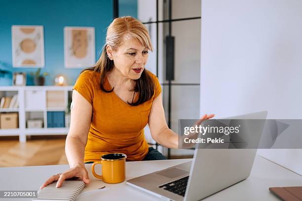 senior woman working from home on laptop - type 1 diabetes stock pictures, royalty-free photos & images