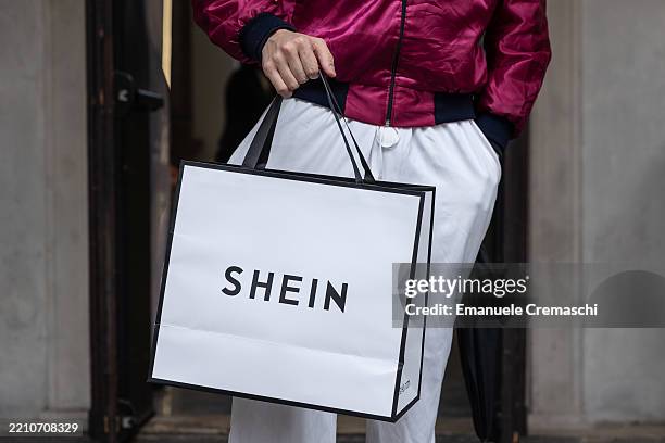 Man holds a bag as he leaves the SHEIN’s “Spring Boutique” temporary store at Palazzo dei Giureconsulti on March 23, 2024 in Milan, Italy. SHEIN, a...