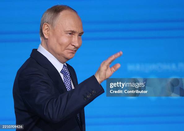 Putin Wave Russian President Vladimir Putin waves during an awarding ceremony at ...