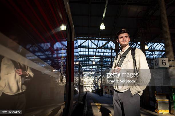 solo traveller waiting for train - edinburgh scotland stock pictures, royalty-free photos & images