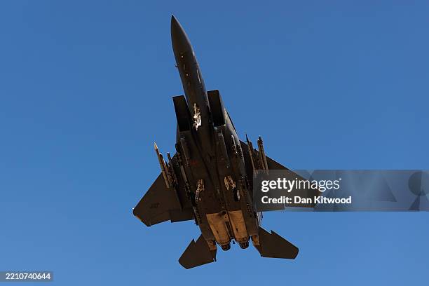 Air Force F-15 Strike Eagle fighter aircraft comes in to land as protesters stage a peaceful demonstration outside RAF Lakenheath on April 17, 2025...