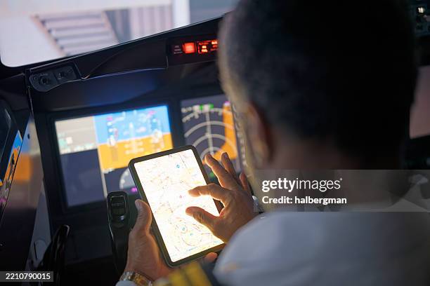 commercial pilot reviews a aviation chart before takeoff - piloting stock pictures, royalty-free photos & images
