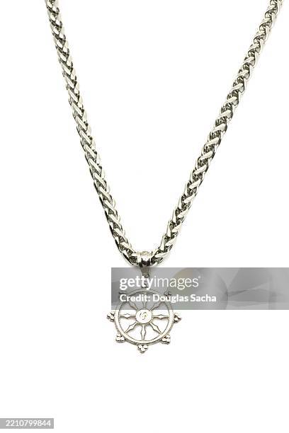 necklace with as buddhism wheel of dharma - pendant stock pictures, royalty-free photos & images