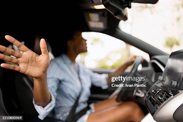 person driving car making a gesture inside modern vehicle - directing stock pictures, royalty-free photos & images