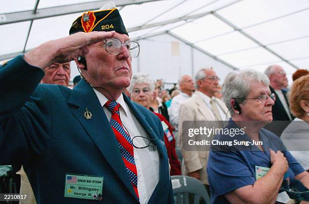 Veteran who participated in the Korean War salutes during a ceremony July 27, 2003 in the border village of Panmunjom in the demilitarized zone...