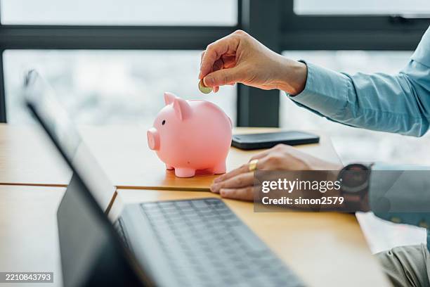 a coin for tomorrow: businessman’s investment mindset - wages stock pictures, royalty-free photos & images