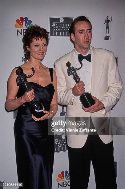 American actress Susan Sarandon, wearing a black dress, and American actor Nicolas Cage, who wears a white tuxedo and a black bow tie, in the 2nd...