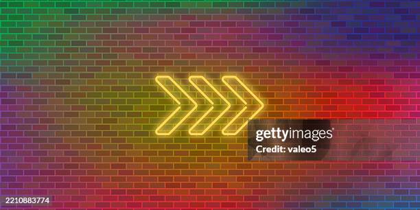 vector brick wall background. yellow neon arrow. abstract colorful brick pattern - yellow brick road stock illustrations