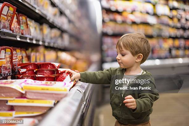 young child choosing groceries in a supermarket - ready to eat stock pictures, royalty-free photos & images