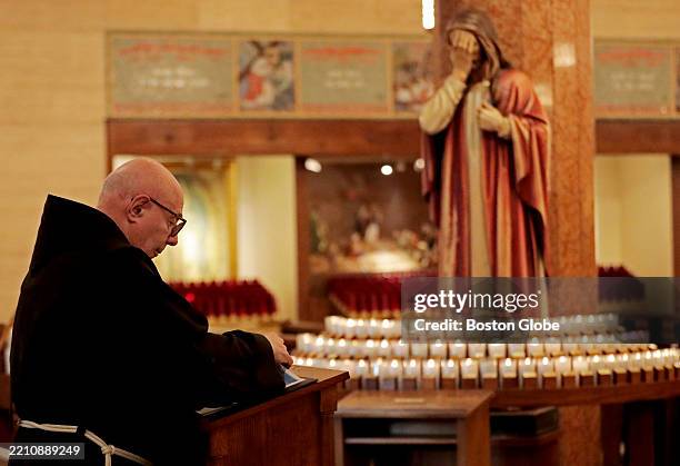 Boston, MA Brother Tony Logalbo changes the pages in a book for prayers for the dead in St. Anthony Shrine on Easter Monday, April 21 after the...