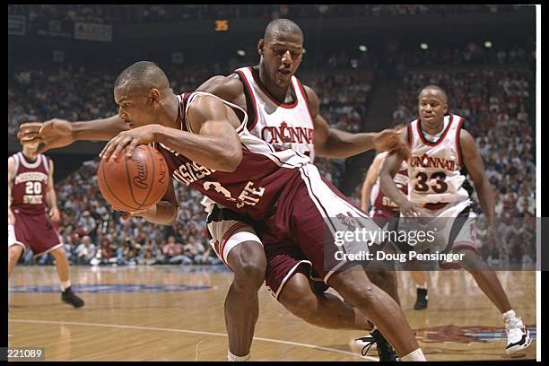 Guard Marcus Bullard of the Mississippi State Bulldogs and forward Rodrick Monroe of the Cincinnati Bearcats fight for the ball during a game at Rupp...