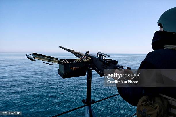 Ukrainian Navy serviceman stands at a machine gun on board a cutter while on patrol in the Black Sea along the coast of Odesa, Ukraine, on April 17,...