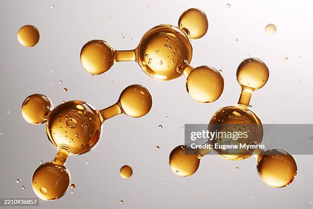 golden molecules floating and connecting, representing innovation in cosmetics - fórmula química fotografías e imágenes de stock