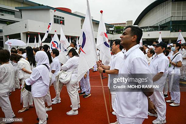 Members of the ruling People's Action Party gather at a nomination centre to support their candidates ahead of the general election in Singapore on...