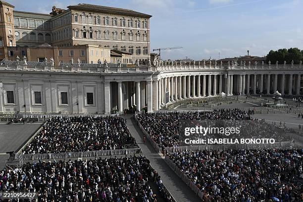 Attendees sit at St Peter's Square during the ceremony following the procession of the coffin of the late Pope, transported from the chapel of Santa...