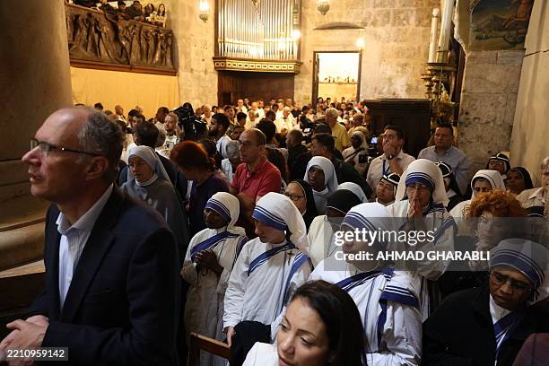 Worshippers attend a memorial mass for Pope Francis at the Church of the Holy Sepulchre in Jerusalem on April 23, 2025. Pope Francis, who died on...