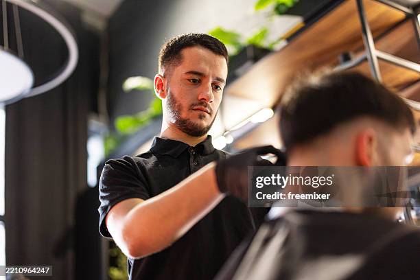 young male client in a barber shop - frisör bildbanksfoton och bilder