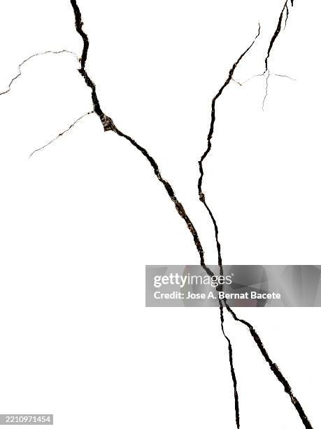 cracks and fissures on a white facade. - adobe material stock pictures, royalty-free photos & images