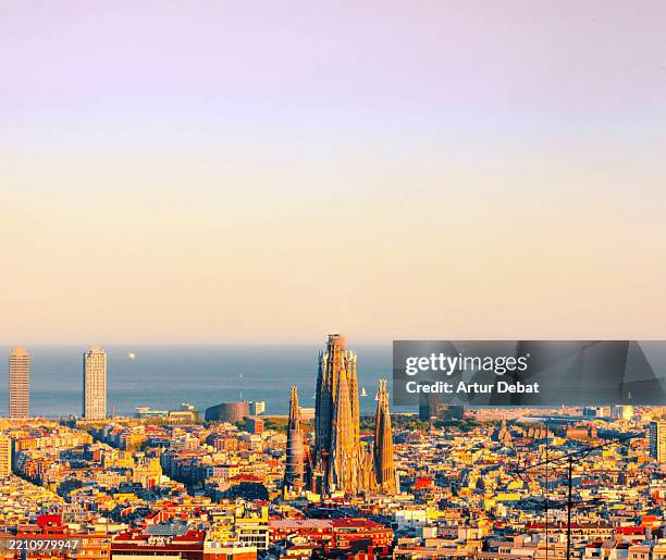 aerial view of the barcelona cityscape with the sagrada familia during the golden hour - sagrada familia barcelona stock pictures, royalty-free photos & images