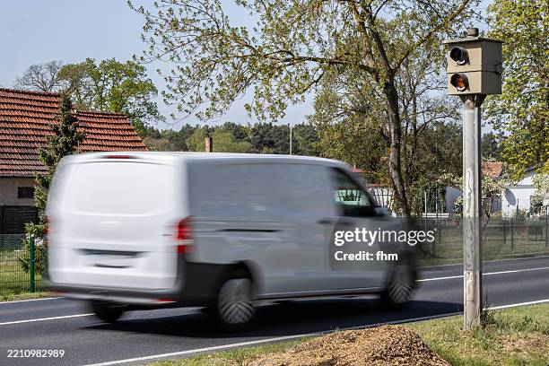 speed control camera with fast white transporter van - speeding camera stock pictures, royalty-free photos & images